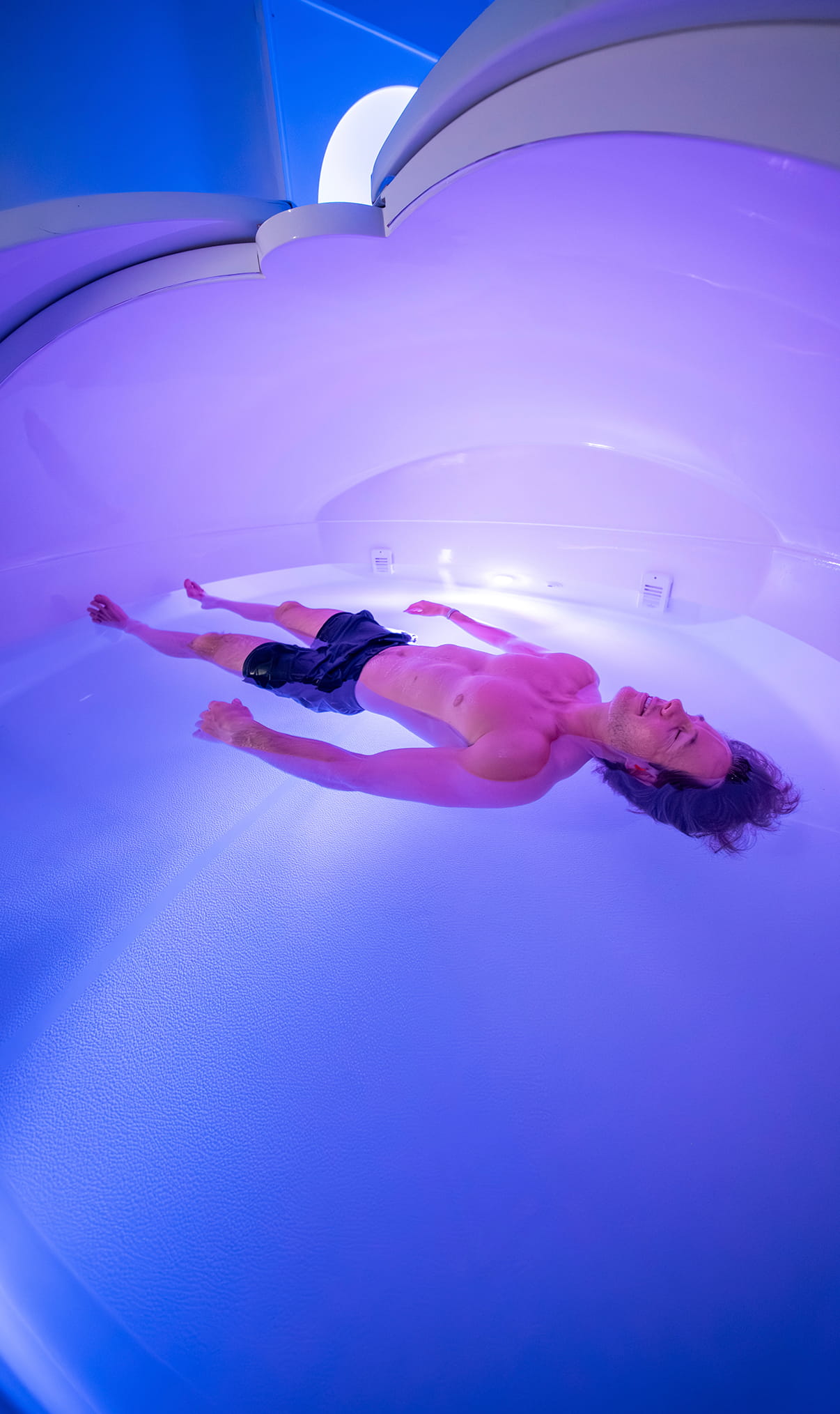 Man floating in a float therapy tank