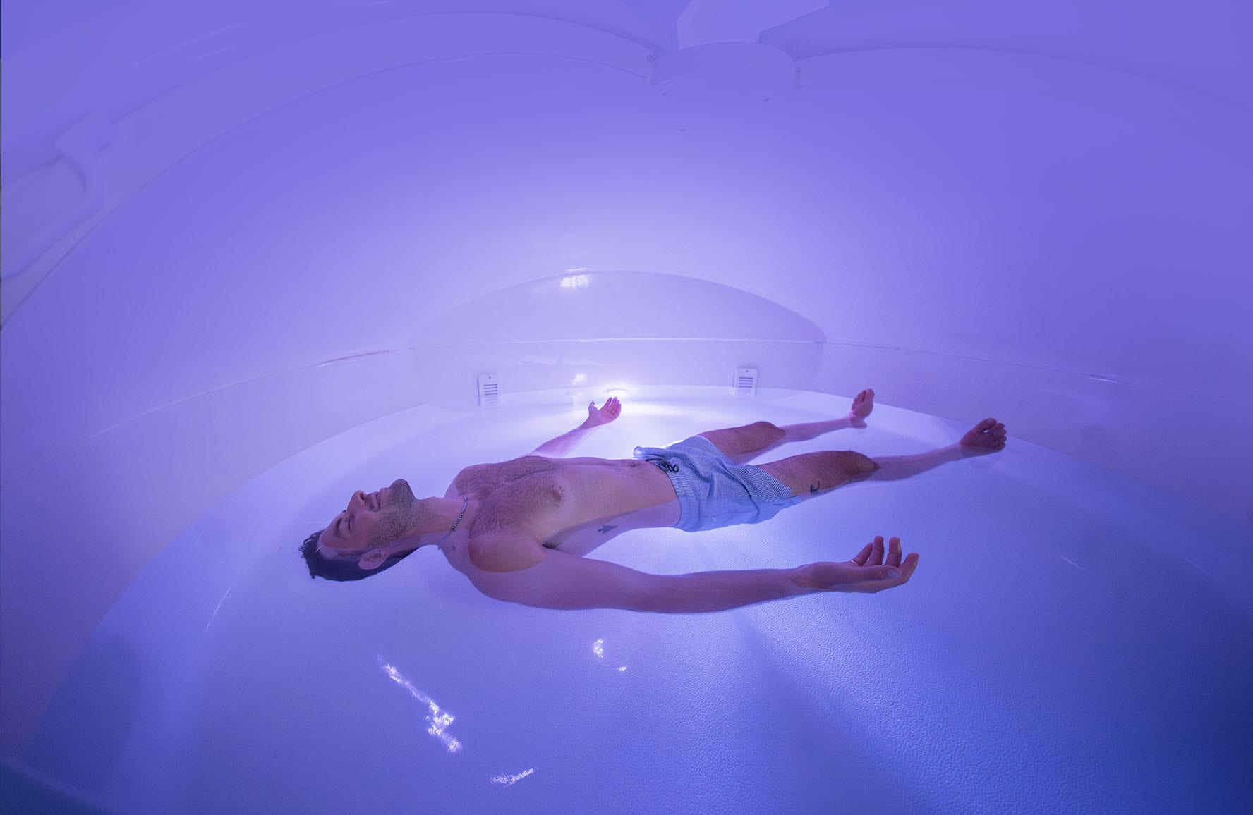 Man floating in a float therapy tank