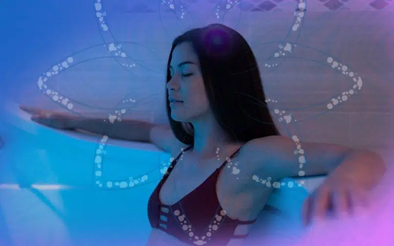 Woman relaxing in a float pod during a flotation therapy session, demonstrating how floatation therapy can help balance the sympathetic and parasympathetic nervous systems.
